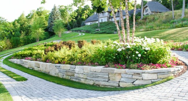 Garden with retaining wall with a wrap around stone walk way