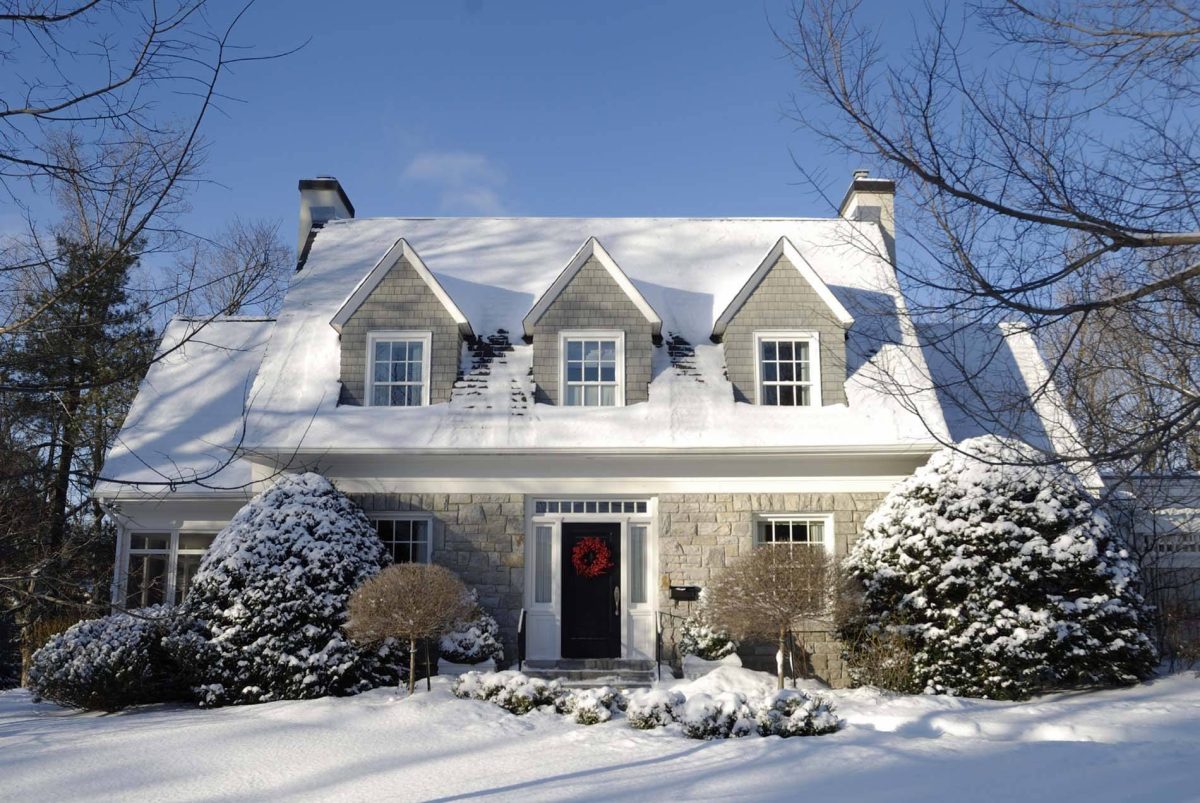 Front of a home with bushes in the winter
